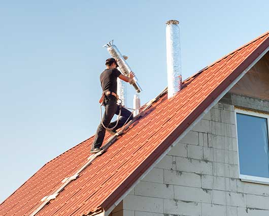 Man Installing Air Ducts for Chimney