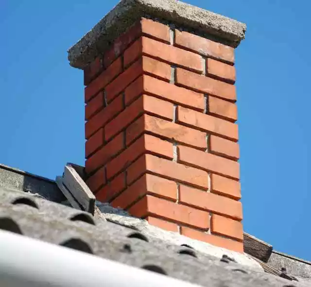 Man Repairing Brick Damaged Chimney